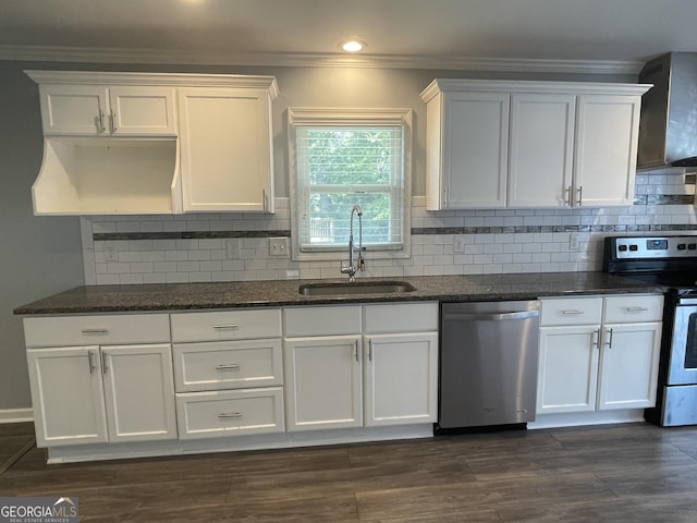 1833 Phillips Ave, East Point, GA 30344 - kitchen with appliances with stainless steel finishes, ornamental molding, white cabinets, dark stone counters, and recessed lighting