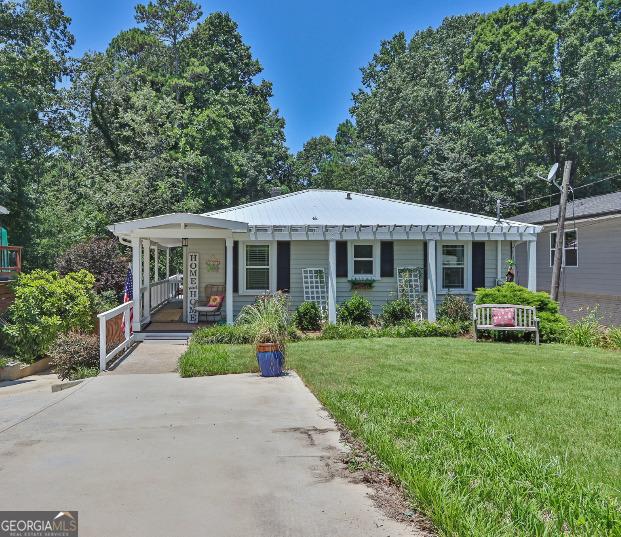 3131 Lee Cir, Buford, GA 30518 - view of front of home with a porch, a front yard, and concrete driveway