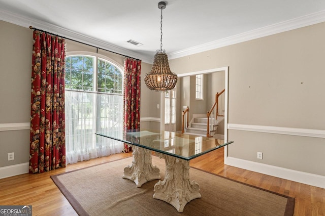 914 Champions Way, Mcdonough, GA 30252 - dining space with a chandelier, stairway, light wood finished floors, and crown molding