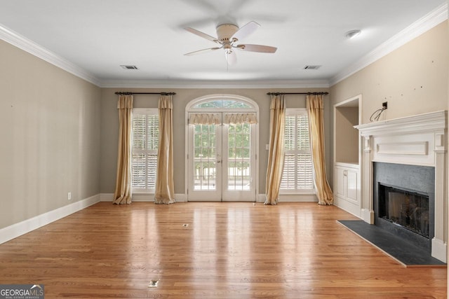 914 Champions Way, Mcdonough, GA 30252 - unfurnished living room with a ceiling fan, a fireplace with flush hearth, light wood finished floors, crown molding, and french doors