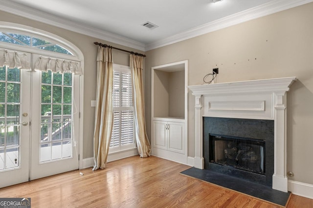 914 Champions Way, Mcdonough, GA 30252 - doorway to outside with a high end fireplace, wood finished floors, french doors, and ornamental molding