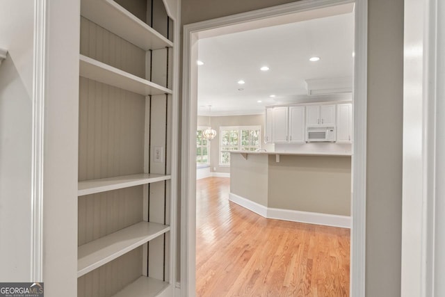 914 Champions Way, Mcdonough, GA 30252 - corridor featuring crown molding, light wood-style floors, recessed lighting, and a chandelier