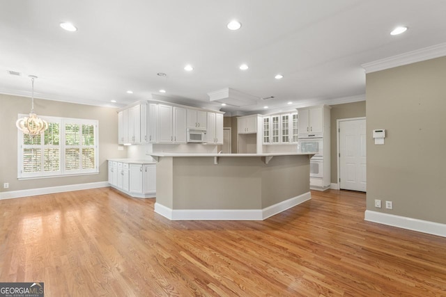 914 Champions Way, Mcdonough, GA 30252 - kitchen with white appliances, ornamental molding, recessed lighting, light wood-style flooring, and white cabinetry