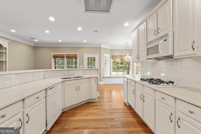 914 Champions Way, Mcdonough, GA 30252 - kitchen featuring white appliances, ornamental molding, light wood-style floors, recessed lighting, and white cabinetry