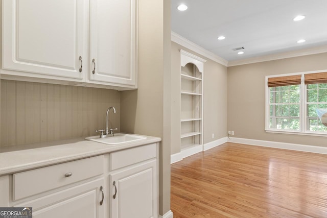914 Champions Way, Mcdonough, GA 30252 - bar featuring crown molding, light wood-style floors, recessed lighting, and built in features