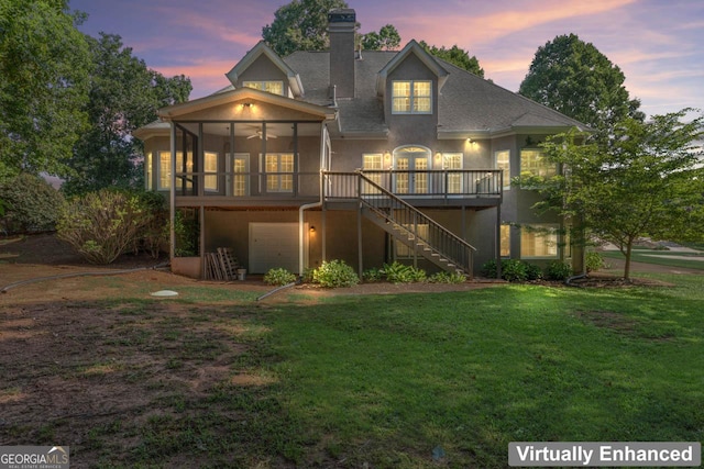 914 Champions Way, Mcdonough, GA 30252 - back of house at dusk featuring stairway, stucco siding, a lawn, and a chimney