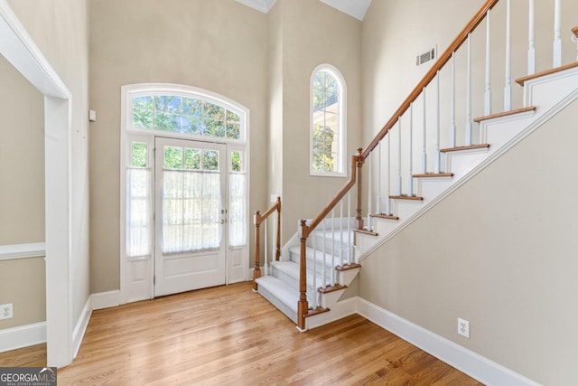 914 Champions Way, Mcdonough, GA 30252 - foyer with stairway, wood finished floors, and a towering ceiling