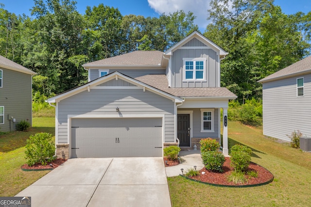 264 Golden Eagle Pkwy, Braselton, GA 30517 - craftsman house featuring board and batten siding, a front lawn, driveway, a garage, and a shingled roof
