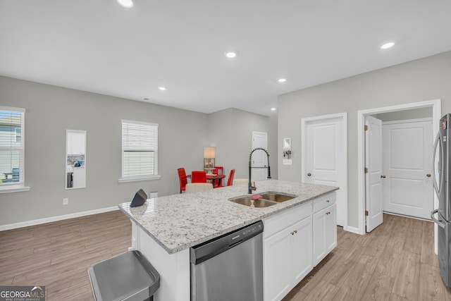 264 Golden Eagle Pkwy, Braselton, GA 30517 - kitchen featuring appliances with stainless steel finishes, light wood finished floors, white cabinets, healthy amount of natural light, and recessed lighting