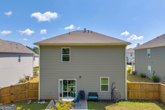 264 Golden Eagle Pkwy, Braselton, GA 30517 - back of property featuring a fenced backyard, a patio, and a gate