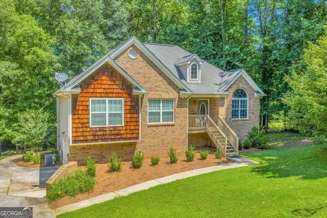 536 Sam Brown Blvd, Commerce, GA 30529 - view of front of house with a front yard, brick siding, a shingled roof, and view of scattered trees