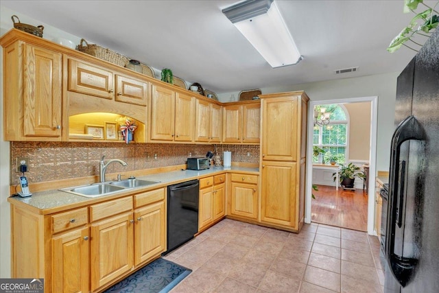 536 Sam Brown Blvd, Commerce, GA 30529 - kitchen featuring black appliances, light countertops, tasteful backsplash, and light tile patterned floors