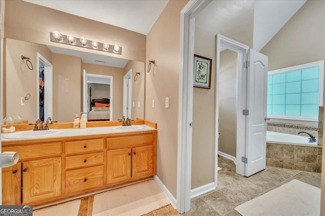 536 Sam Brown Blvd, Commerce, GA 30529 - ensuite bathroom with a garden tub, double vanity, tile patterned floors, and lofted ceiling