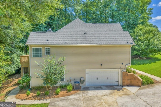 536 Sam Brown Blvd, Commerce, GA 30529 - view of home's exterior with an attached garage, driveway, roof with shingles, and a chimney