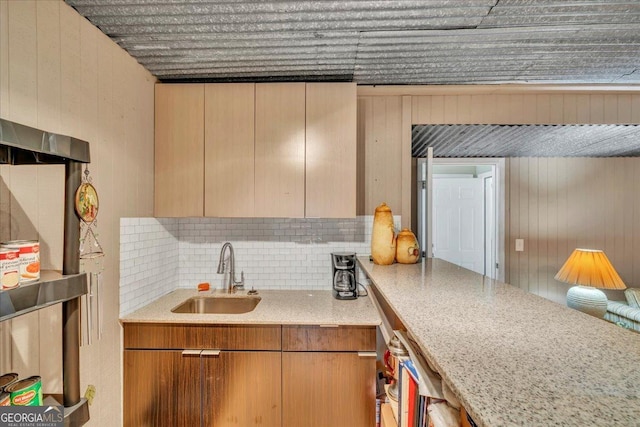536 Sam Brown Blvd, Commerce, GA 30529 - kitchen with tasteful backsplash, wood walls, and light stone countertops
