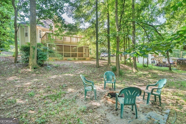 536 Sam Brown Blvd, Commerce, GA 30529 - view of yard featuring a sunroom, an outdoor fire pit, and a wooden deck