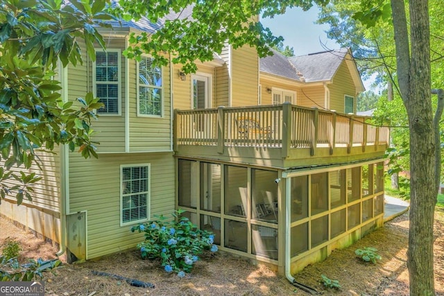 536 Sam Brown Blvd, Commerce, GA 30529 - rear view of house featuring a sunroom, a shingled roof, and a balcony