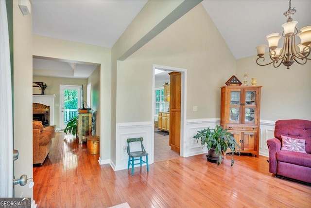 536 Sam Brown Blvd, Commerce, GA 30529 - sitting room with wood-type flooring, a chandelier, a wainscoted wall, and a fireplace