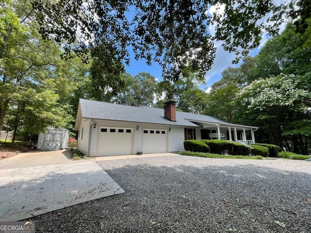77 Chestatee Dr, Blairsville, GA 30512 - single story home featuring gravel driveway, an attached garage, a storage shed, a chimney, and covered porch