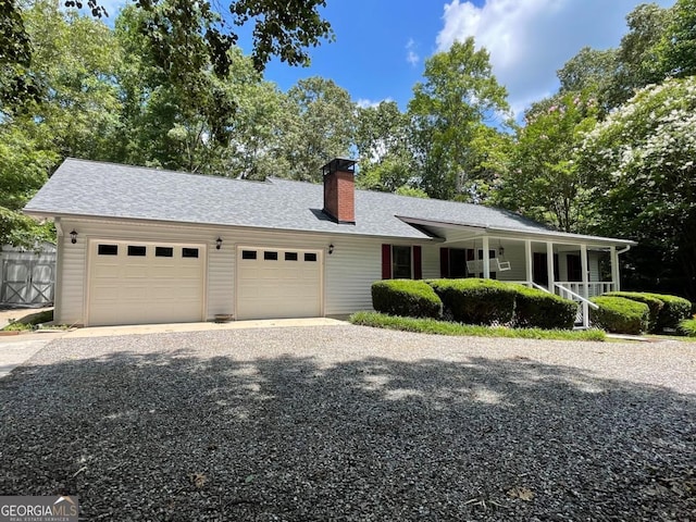 77 Chestatee Dr, Blairsville, GA 30512 - view of front of property featuring a garage, driveway, a porch, a chimney, and roof with shingles