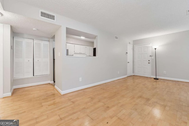 1504 Wingate Way, Atlanta, GA 30350 - spare room featuring light wood-style flooring and a textured ceiling