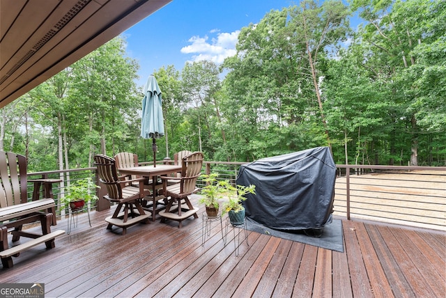 712 Meadow Run Ct, Clarkesville, GA 30523 - wooden deck featuring outdoor dining space, grilling area, and view of wooded area