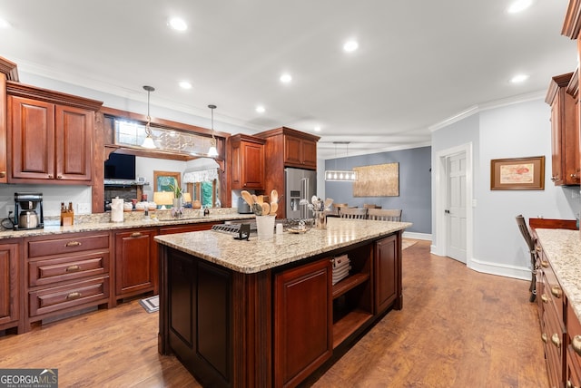712 Meadow Run Ct, Clarkesville, GA 30523 - kitchen with high end refrigerator, crown molding, a kitchen island, decorative light fixtures, and wood finished floors
