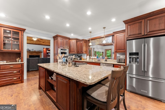 712 Meadow Run Ct, Clarkesville, GA 30523 - kitchen featuring appliances with stainless steel finishes, a kitchen island, ornamental molding, a breakfast bar area, and light wood finished floors