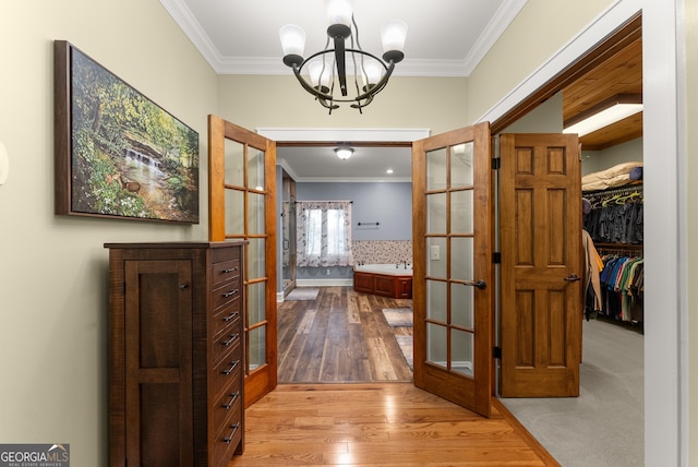 712 Meadow Run Ct, Clarkesville, GA 30523 - hall with french doors, ornamental molding, a chandelier, and wood finished floors