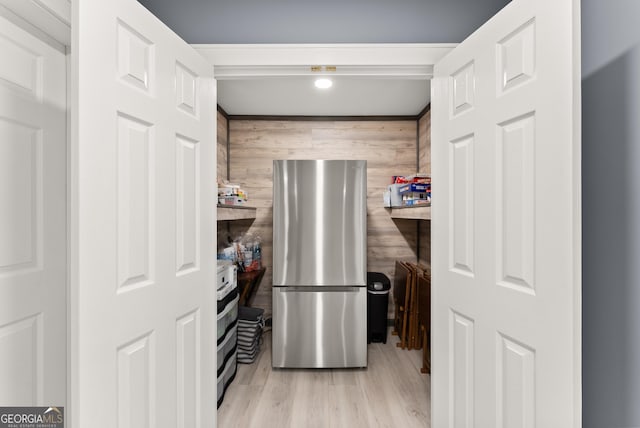 712 Meadow Run Ct, Clarkesville, GA 30523 - kitchen featuring freestanding refrigerator, wood finished floors, and wood walls