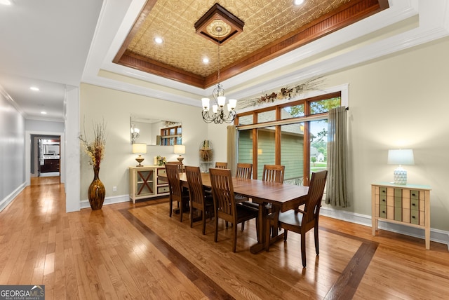 712 Meadow Run Ct, Clarkesville, GA 30523 - dining room featuring a tray ceiling, crown molding, hardwood / wood-style floors, and a chandelier