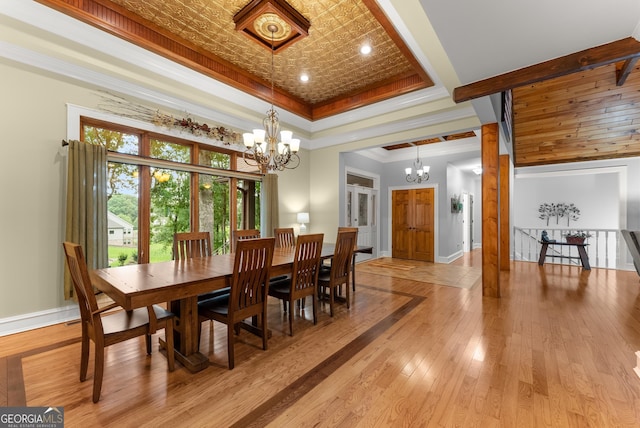 712 Meadow Run Ct, Clarkesville, GA 30523 - dining area featuring a chandelier, light wood-style floors, a tray ceiling, crown molding, and an ornate ceiling