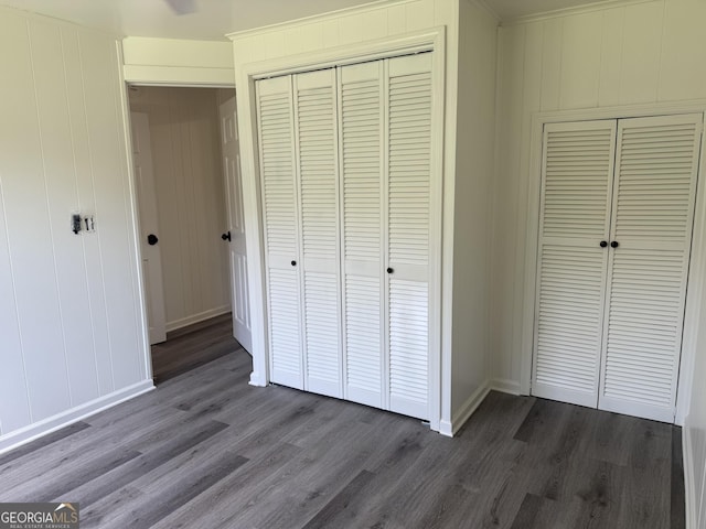 1220 Harmony St, Gainesville, GA 30501 - unfurnished bedroom featuring dark wood finished floors, a decorative wall, and a closet