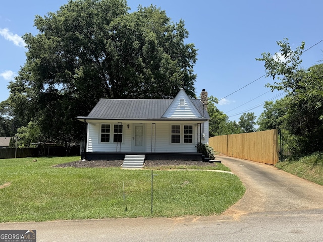 1220 Harmony St, Gainesville, GA 30501 - view of front facade with a porch, a chimney, a metal roof, and driveway