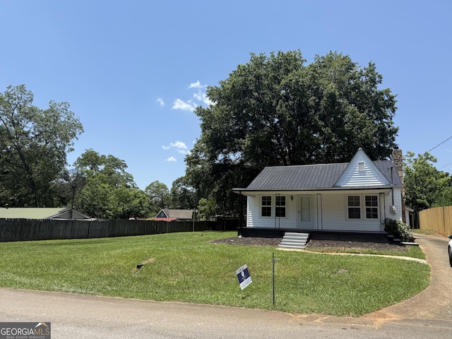 1220 Harmony St, Gainesville, GA 30501 - view of front of house with covered porch, a chimney, and a metal roof