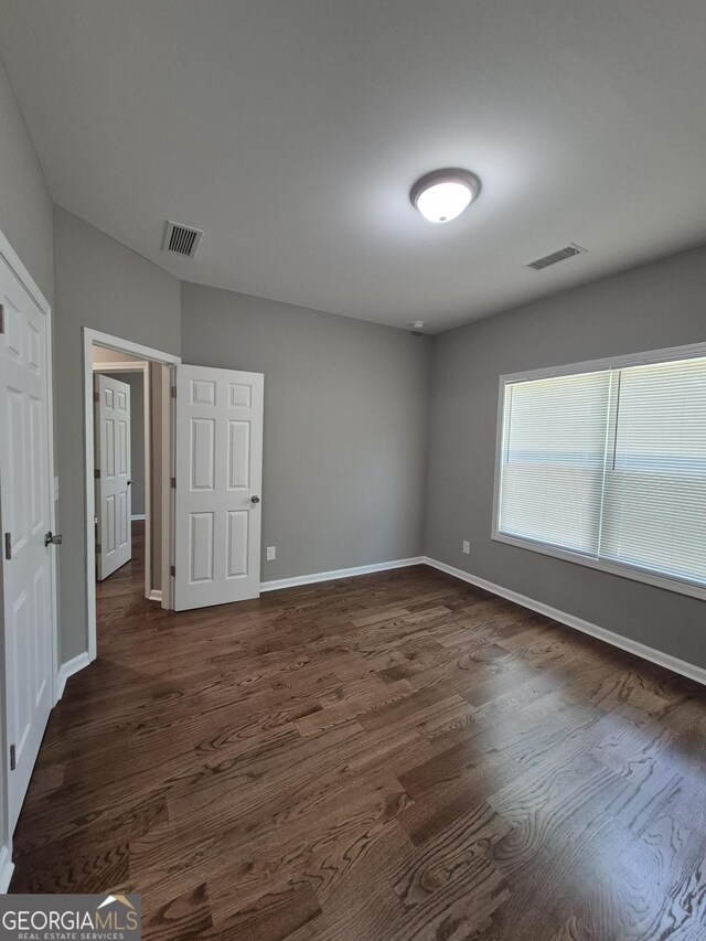 1090 Fox Glen Dr, Watkinsville, GA 30677 - unfurnished bedroom with dark wood-style flooring and baseboards