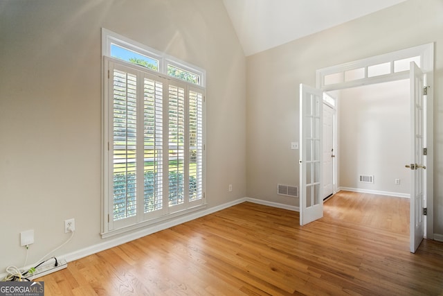 2832 Windrush Dr, Buford, GA 30518 - unfurnished room with wood finished floors, french doors, and high vaulted ceiling