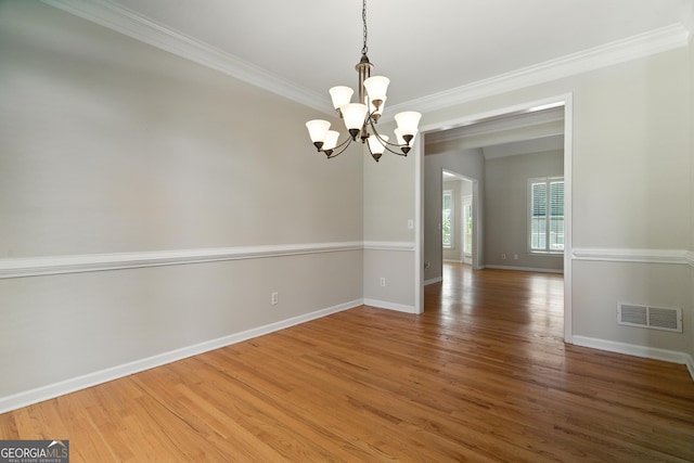 2832 Windrush Dr, Buford, GA 30518 - empty room featuring a chandelier, crown molding, and wood finished floors