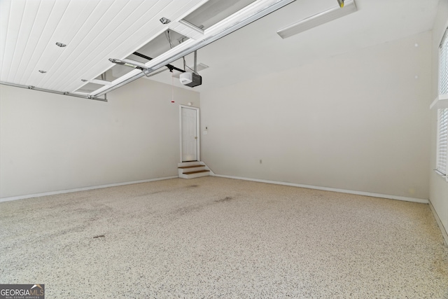 2832 Windrush Dr, Buford, GA 30518 - garage featuring a garage door opener and baseboards