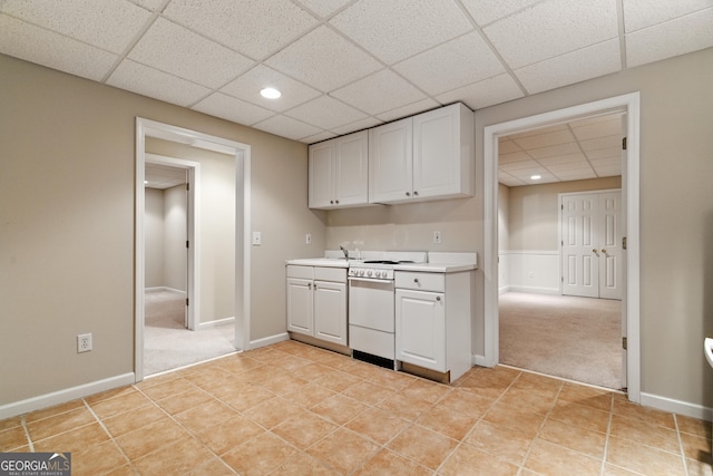 2832 Windrush Dr, Buford, GA 30518 - kitchen featuring a drop ceiling, light carpet, light countertops, white cabinets, and dishwashing machine