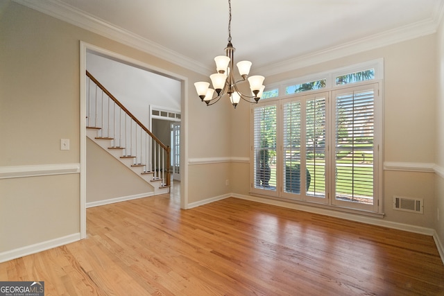 2832 Windrush Dr, Buford, GA 30518 - spare room with a chandelier, light wood-style floors, crown molding, and stairway