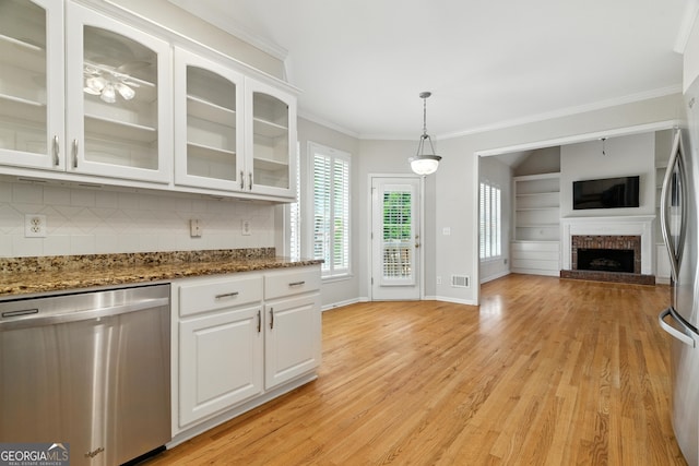 2832 Windrush Dr, Buford, GA 30518 - kitchen with stainless steel appliances, open floor plan, ornamental molding, white cabinetry, and backsplash