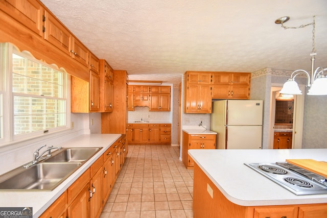 2722 Hidden Valley Rd, Hiawassee, GA 30546 - kitchen featuring freestanding refrigerator, stainless steel electric stovetop, a textured ceiling, light countertops, and a chandelier