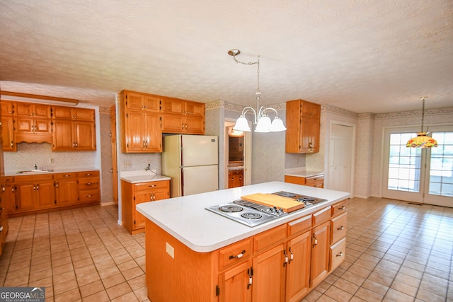 2722 Hidden Valley Rd, Hiawassee, GA 30546 - kitchen with freestanding refrigerator, stainless steel electric cooktop, light countertops, wallpapered walls, and light tile patterned floors