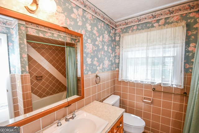 2722 Hidden Valley Rd, Hiawassee, GA 30546 - full bath featuring vanity, shower / bath combo, a wainscoted wall, and tile walls