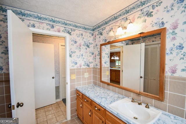 2722 Hidden Valley Rd, Hiawassee, GA 30546 - bathroom with a closet, tile walls, wallpapered walls, vanity, and a wainscoted wall