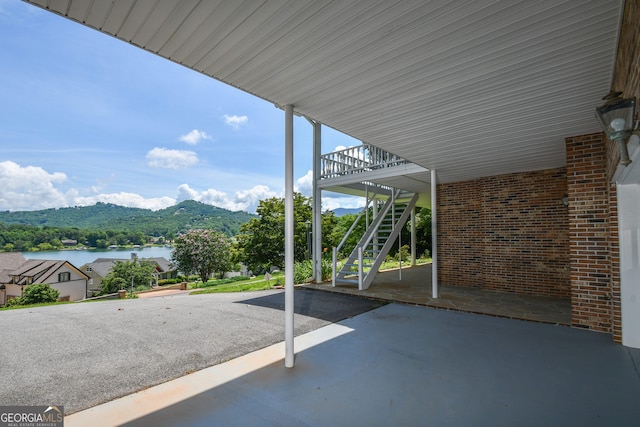2722 Hidden Valley Rd, Hiawassee, GA 30546 - view of patio featuring stairway, a water and mountain view, and a carport