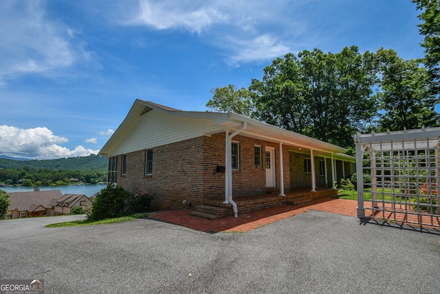 2722 Hidden Valley Rd, Hiawassee, GA 30546 - view of home's exterior with brick siding and covered porch