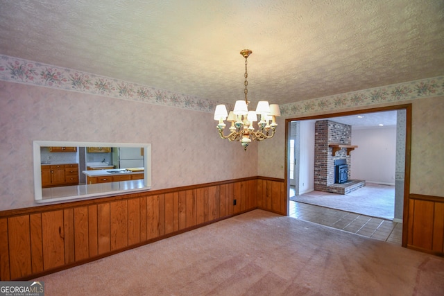 2722 Hidden Valley Rd, Hiawassee, GA 30546 - unfurnished dining area with wainscoting, a chandelier, wallpapered walls, carpet flooring, and wooden walls