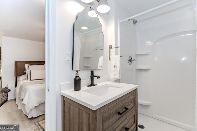 706 Powder Springs St SE, Smyrna, GA 30080 - ensuite bathroom with vanity, a shower, and wood finished floors